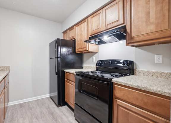 A Kitchen With Wooden Cabinets at Fair Oaks Apartments, Little Rock, Arkansas