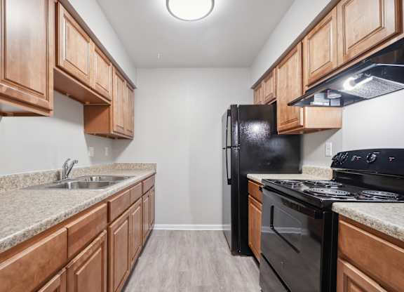 A Kitchen With Black Appliances at Fair Oaks Apartments, Little Rock, 72204