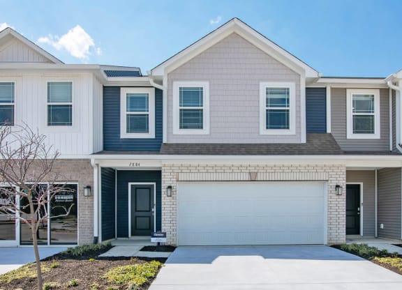 a house with a garage door in front of it at Jackson Run Townhomes, Indiana, 46075