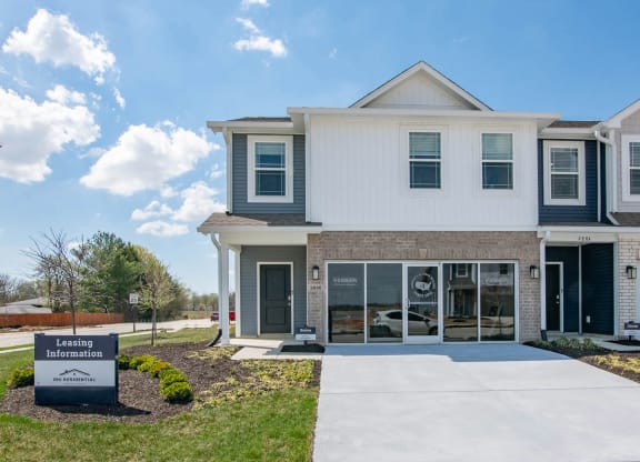 a white house with a sidewalk in front of it at Jackson Run Townhomes, Whitestown, IN