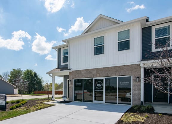 a white building with a sidewalk in front of it at Jackson Run Townhomes, Whitestown, IN 46075