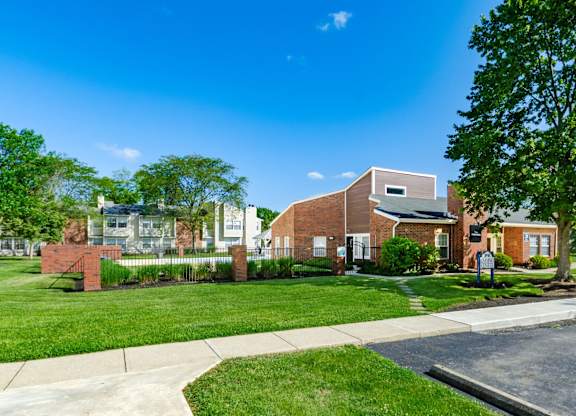 A residential area with houses and a tree.