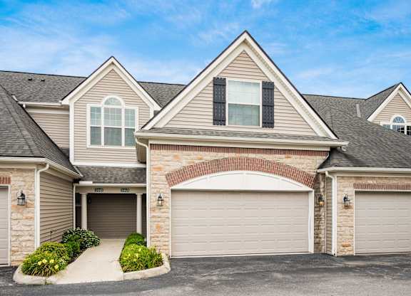 A house with a garage and a driveway. at River View at Bexley Apartments, River View at Bexley, Ohio