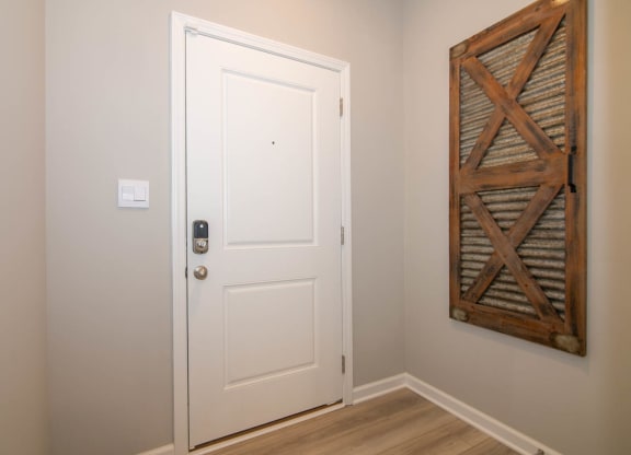 a white door in a room with a wall art at Jackson Run Townhomes, Whitestown Indiana