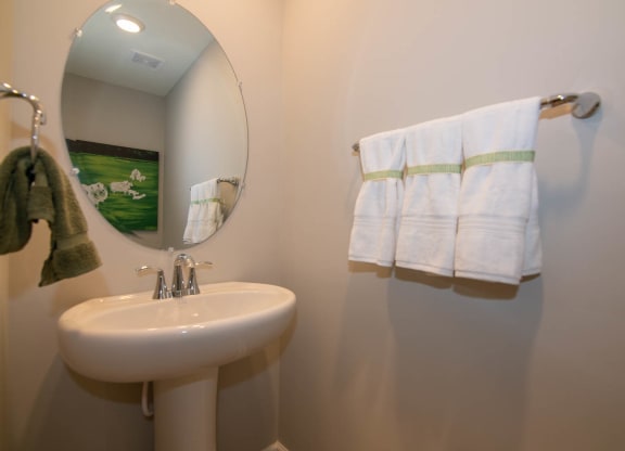 a small bathroom with a sink and a mirror at Jackson Run Townhomes, Whitestown, 46075