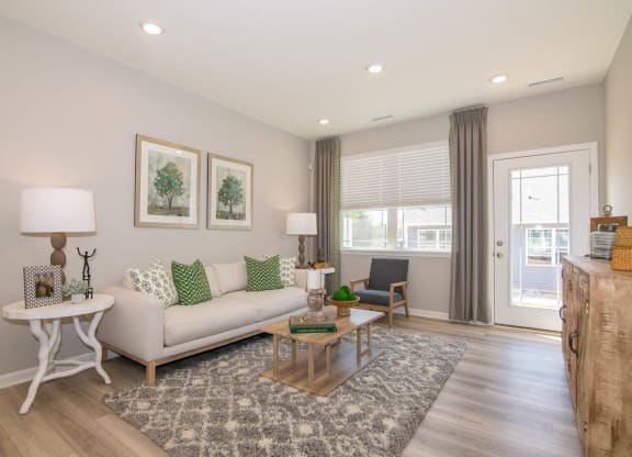 a living room with a couch and a table at Jackson Run Townhomes, Whitestown, 46075
