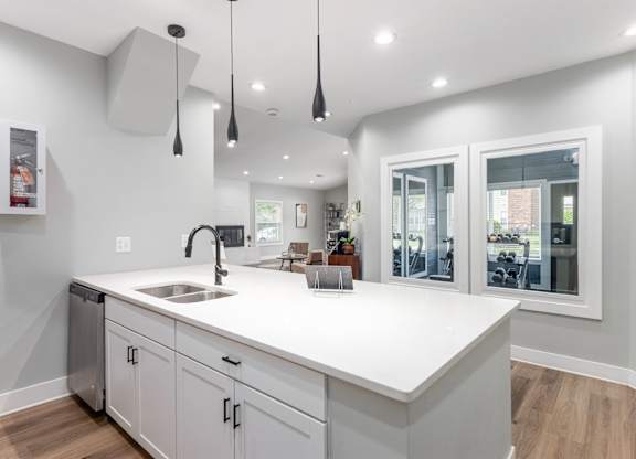 A modern kitchen with white countertops and cabinets.
