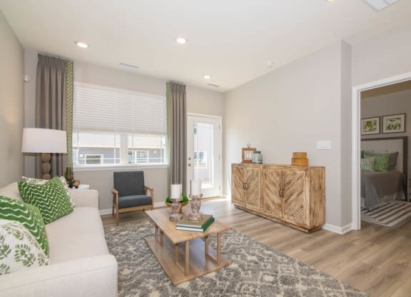 a living room with a couch and a coffee table at Jackson Run Townhomes, Whitestown, IN 46075