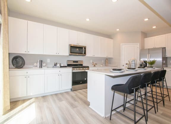 a kitchen with white cabinets and a counter top at Jackson Run Townhomes, Whitestown Indiana