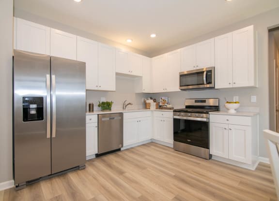a kitchen with stainless steel appliances and white cabinets at Jackson Run Townhomes, Indiana, 46075