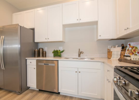 a kitchen with white cabinets and a stainless steel refrigerator at Jackson Run Townhomes, Whitestown, 46075