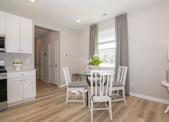 a dining room with a table and chairs at Jackson Run Townhomes, Whitestown, IN 46075