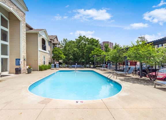 the preserve at ballantyne commons resort style swimming pool with trees and apartment buildings