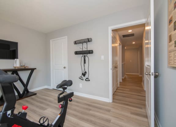 a home gym with weights and a tv at Jackson Run Townhomes, Whitestown Indiana