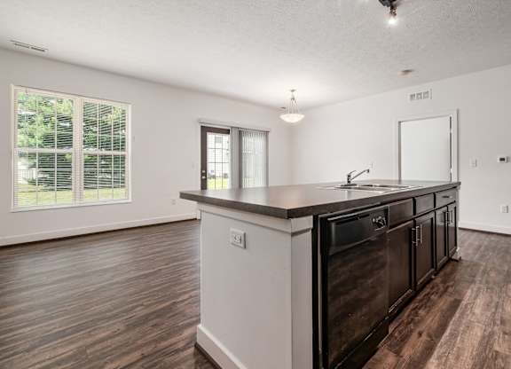 A kitchen with dark wood floors and white walls. at River View at Bexley Apartments, Ohio, 43209