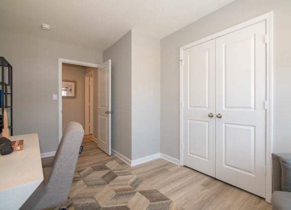 a living room with white doors and a hallway to a bedroom at Jackson Run Townhomes, Whitestown, IN