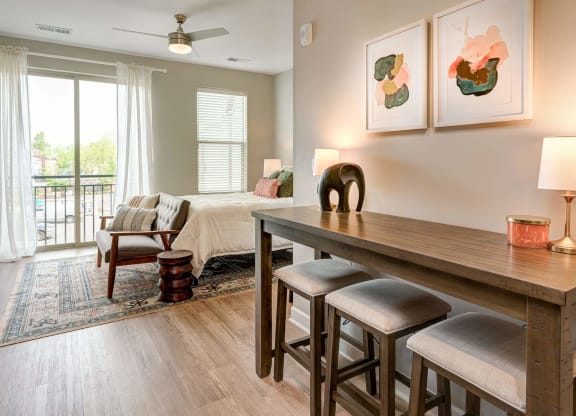a living room and dining room with a table and chairs at Adelphi Quarter, Columbus, OH