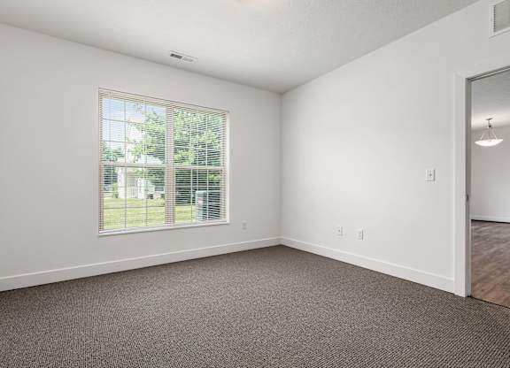 A room with a window and a door. at River View at Bexley Apartments, River View at Bexley, Ohio