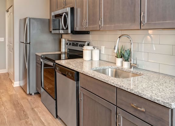a kitchen with stainless steel appliances and granite counter tops at Adelphi Quarter, Ohio