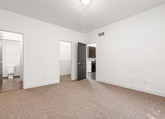 A carpeted room with a toilet and a black cabinet. at River View at Bexley Apartments, Ohio, 43209