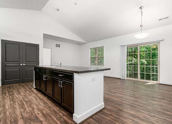 A kitchen with dark brown cabinets and white countertops. at River View at Bexley Apartments, River View at Bexley 43209