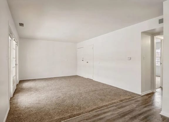 a room with a carpeted floor and white walls