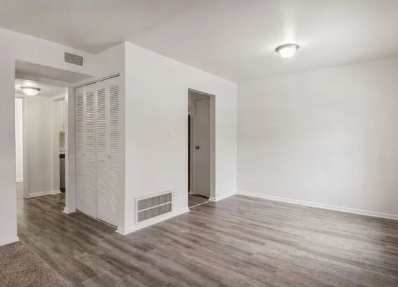 a room with a wooden floor and white walls