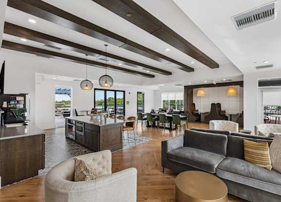 A modern living room with a grey couch and a wooden ceiling.