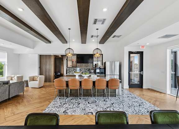 A modern dining room with a large table and chairs.