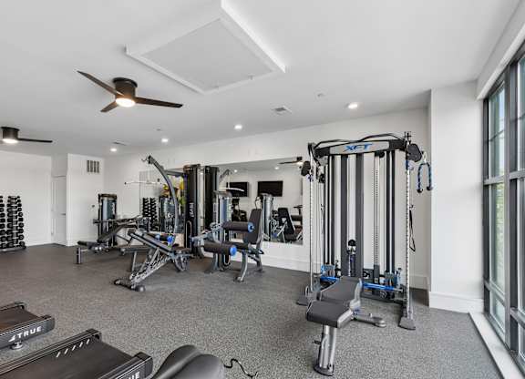 A spacious home gym with a variety of equipment.