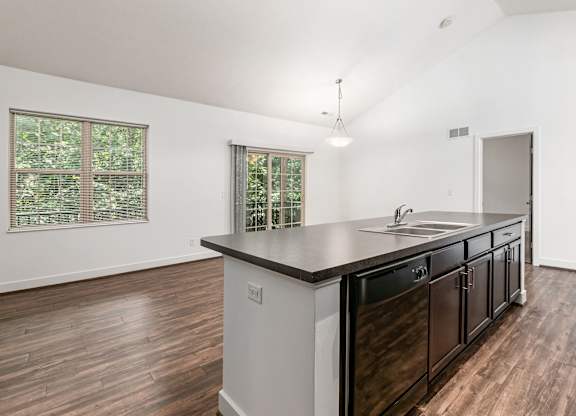 A kitchen with a large island and wooden floors. at River View at Bexley Apartments, River View at Bexley, OH