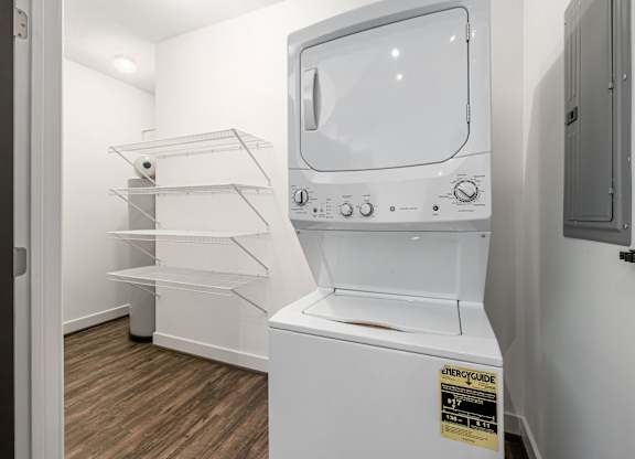 A white microwave oven with a sticker on it. at River View at Bexley Apartments, River View at Bexley, Ohio