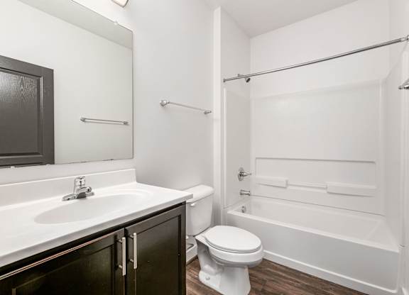 A white bathroom with a toilet, sink, and bathtub. at River View at Bexley Apartments, Ohio, 43209