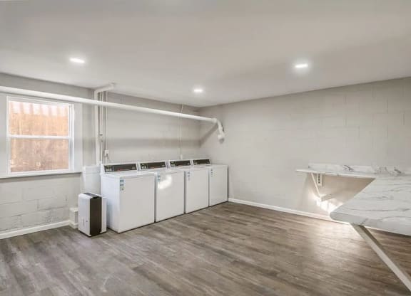 a room with two washers and a sink