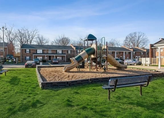 a playground with two slides and a bench