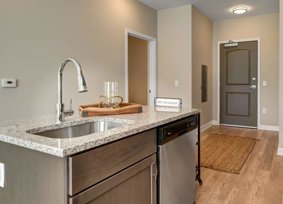 a kitchen with a sink and a door to a hallway at Adelphi Quarter, Columbus, OH, 43203