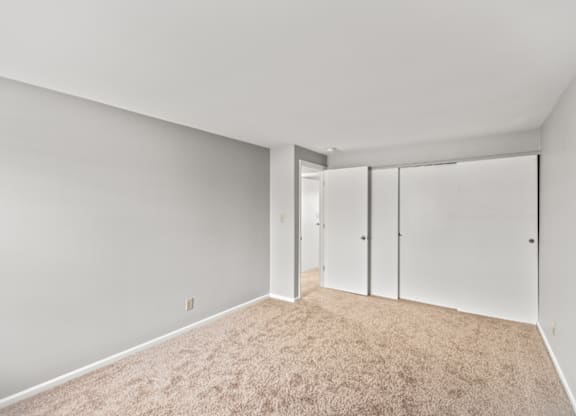 A room with a carpeted floor and white walls.