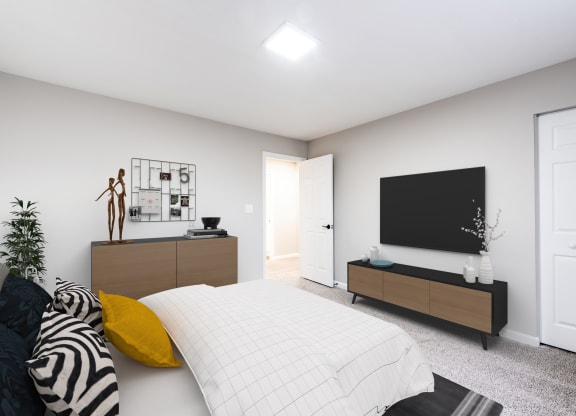 a bedroom with a large bed in front of a tv