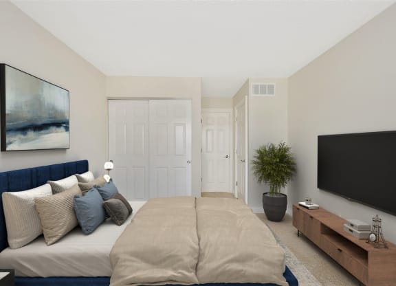 a bedroom with a large bed in front of a tv at Harpers Point Apartments, Ohio