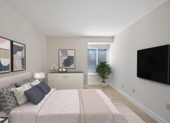 a bedroom with a large bed and a flat screen tv at Harpers Point Apartments, Ohio, 45249