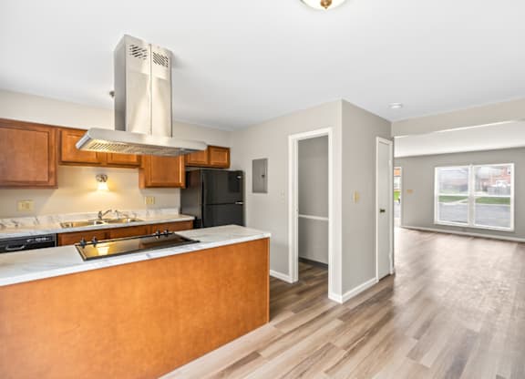 A modern kitchen with wooden cabinets and a large island.