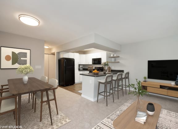a spacious living room with a dining room table and chairs and a kitchen with a refrigerator  at 7 Pointe Apartments, Indianapolis