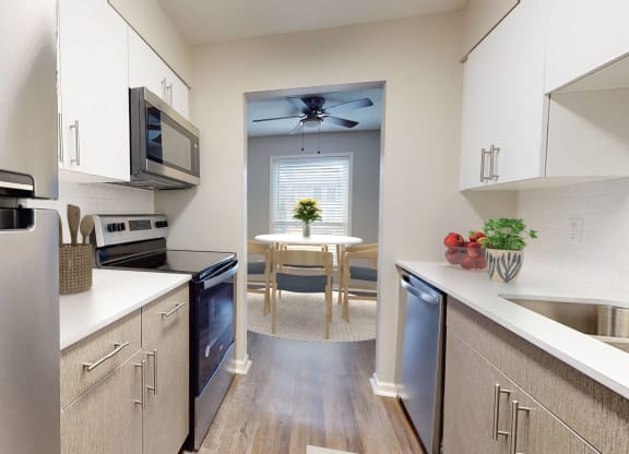 Kitchen and dining room with stainless steel appliances and a ceiling fan at Summit at Keystone, Indiana, 46220