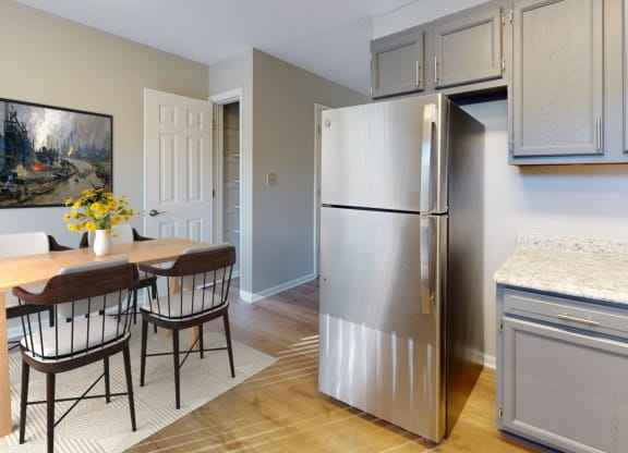 a kitchen with a stainless steel refrigerator and a table and chairs at Ridgeview, Indiana, 46040