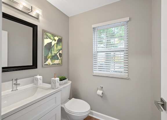 a bathroom with a toilet and a sink and a window at Indian Creek Apartments*, Ohio, 45236
