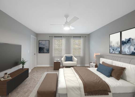 a master bedroom with a large bed and a ceiling fan at Indian Creek Apartments*, Cincinnati, OH