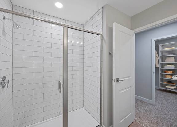 a white bathroom with a shower and a closet at Indian Creek Apartments*, Ohio, 45236