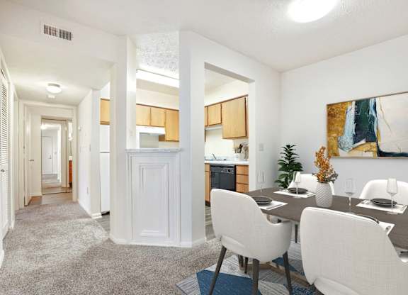 A dining room with a table set for four.