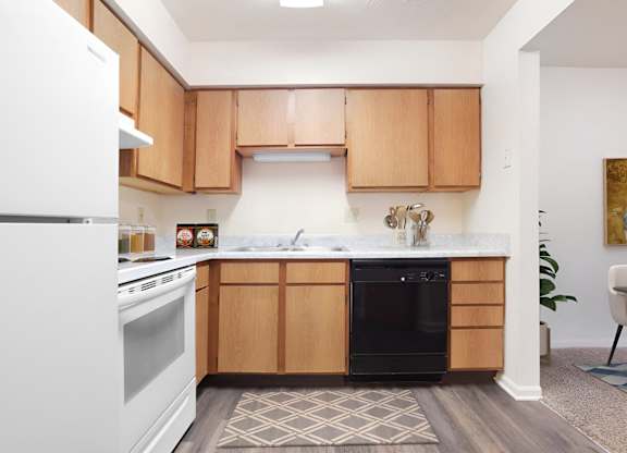 A kitchen with wooden cabinets and a white refrigerator.