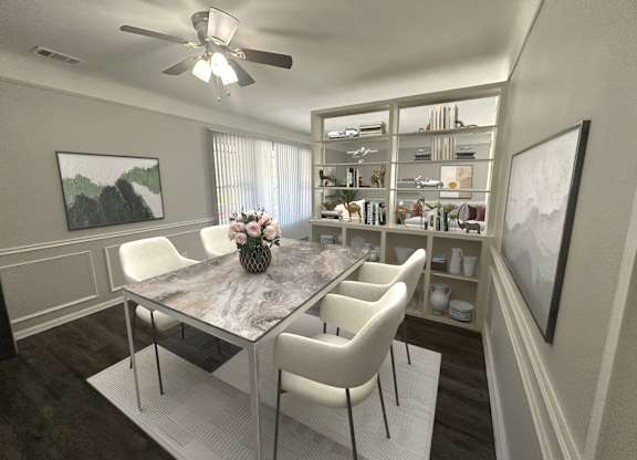 A dining room with a table and chairs.